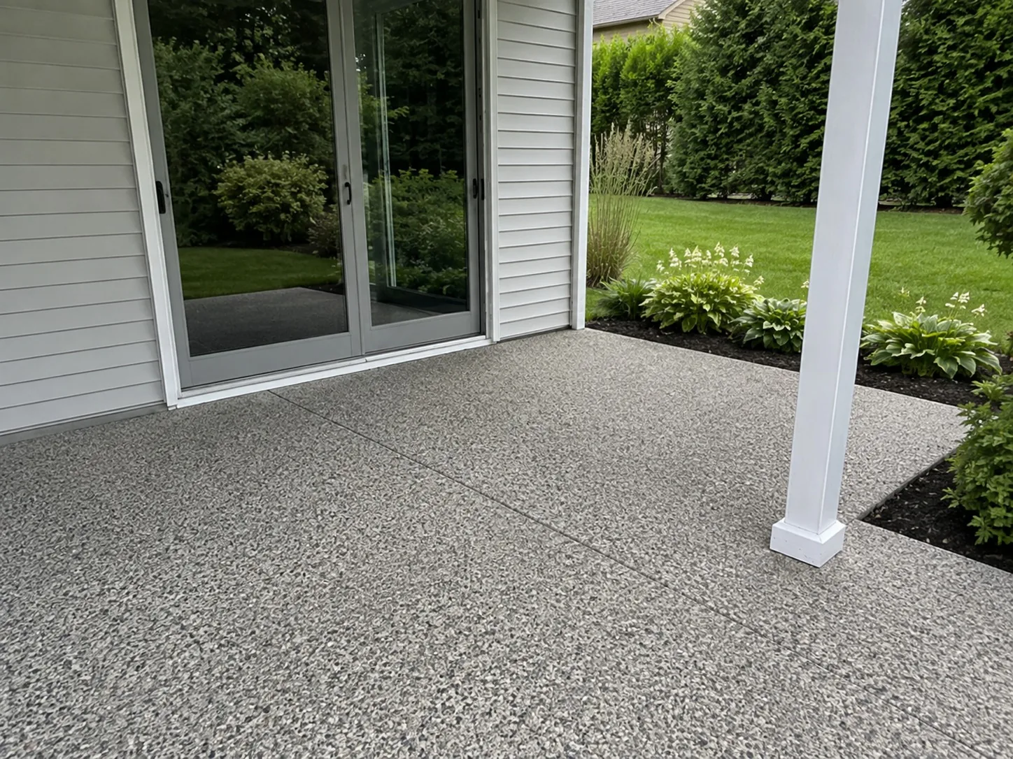 Exposed aggregate patio beside the sliding doors of a Melbourne home