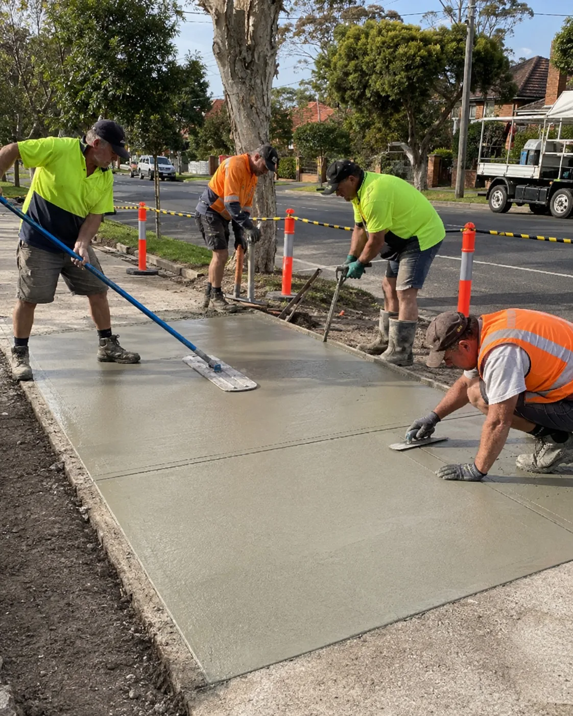 Crew screeding a replacement concrete driveway on a Melbourne street