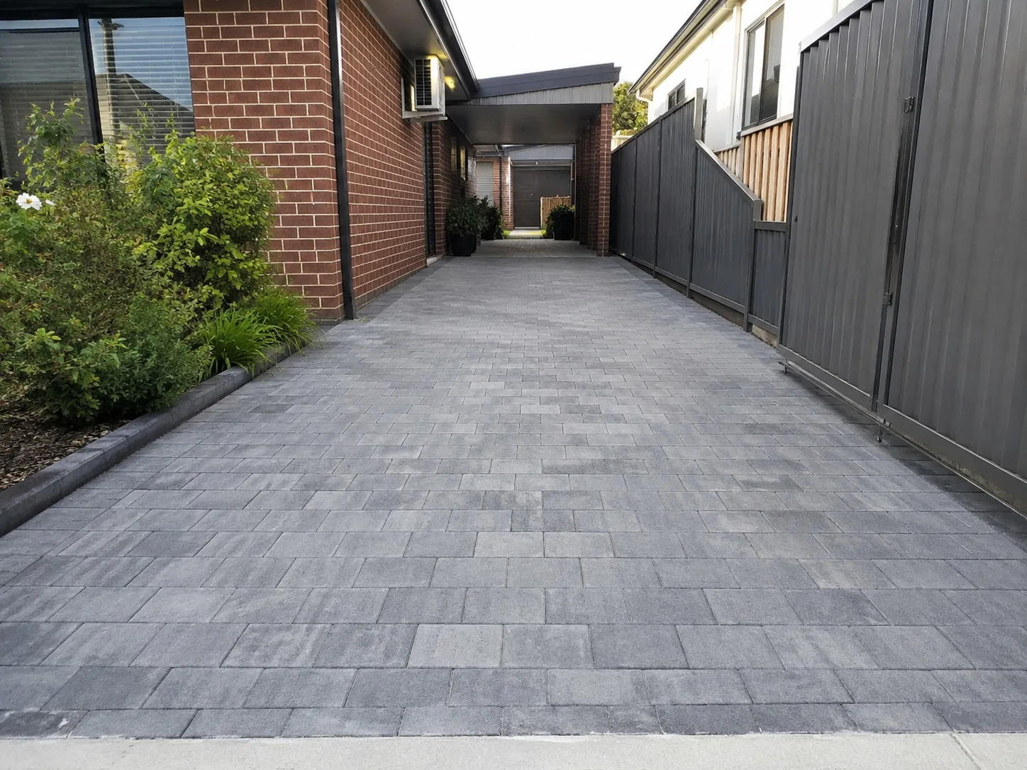 Paver-pattern stencil concrete running down the side access of a Melbourne home